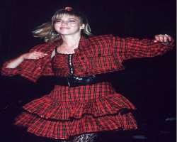 Her plaid ruffled skirt which she wore in her performance was designed by her sister Michele.